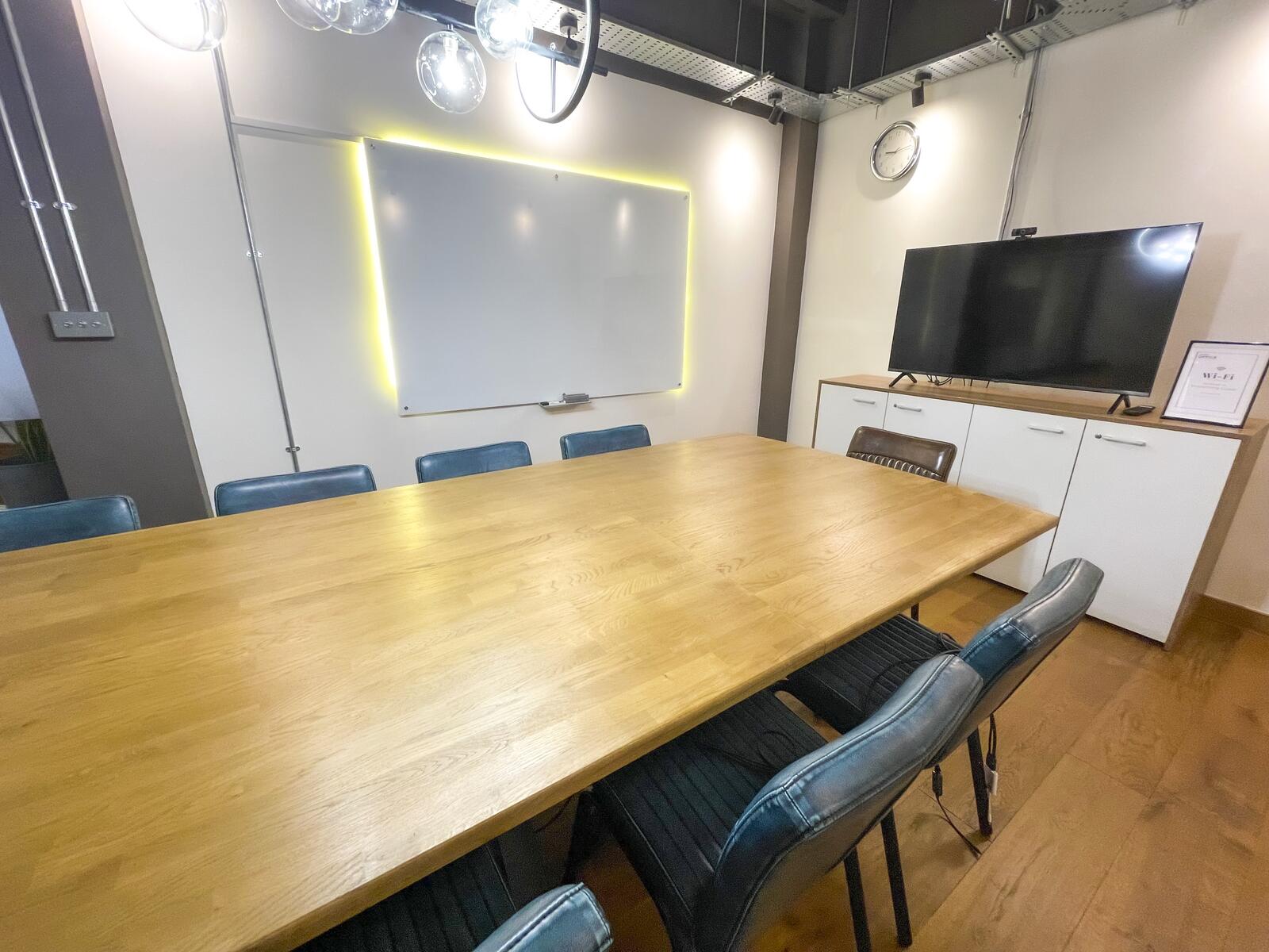 Close-up of boardroom table with leather chairs in meeting room