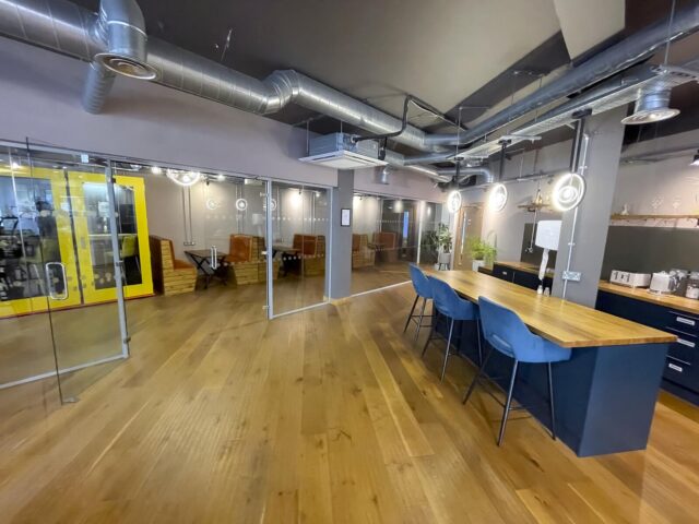 Open-plan event space with kitchen area and seating in ShoreditchThe Lower Deck event space featuring an open-plan layout with kitchen area, seating and wooden flooring in a modern Shoreditch setting.